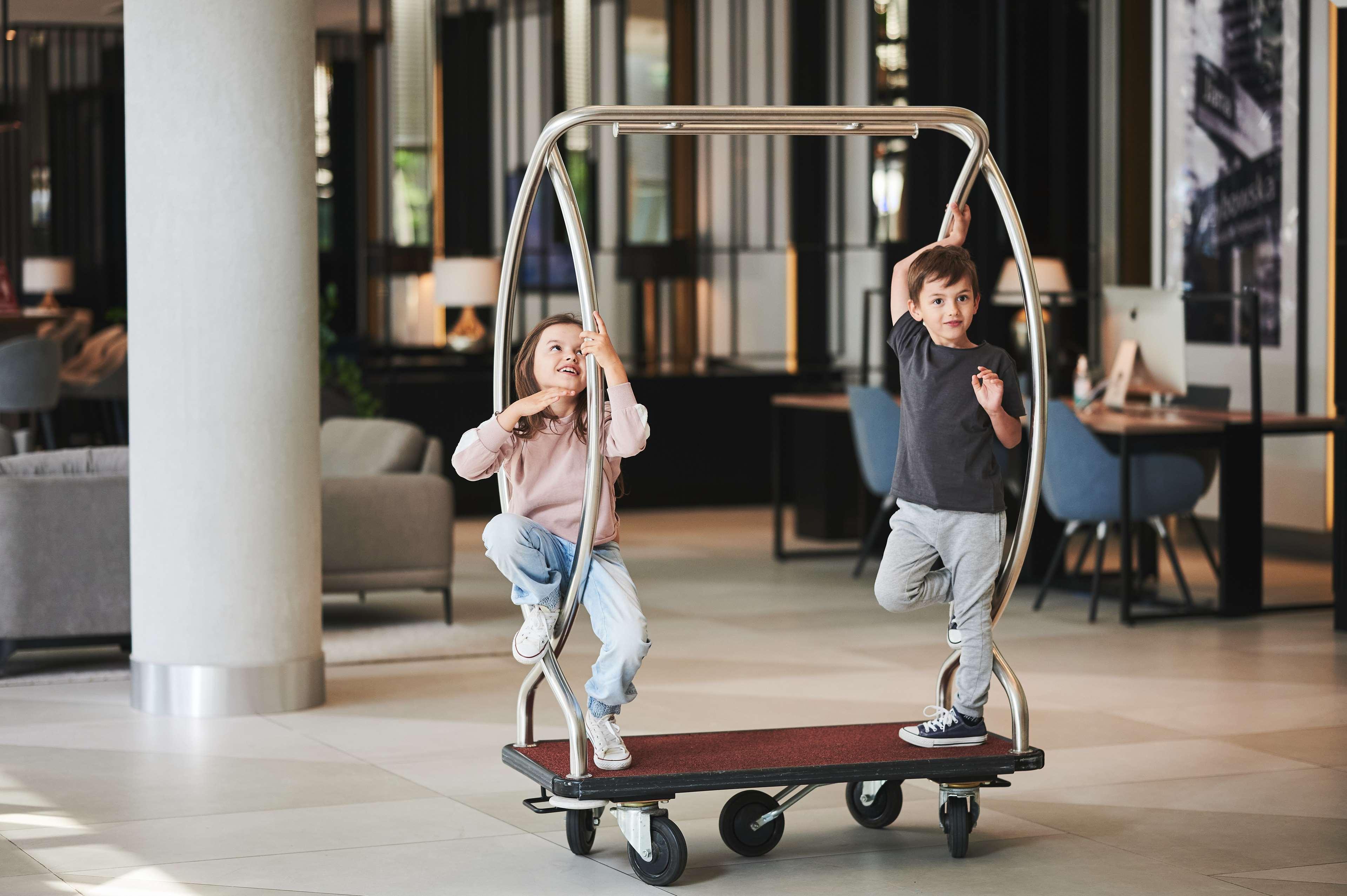 Radisson Collection Hotel, Варшава Екстериор снимка Kids on luggage cart